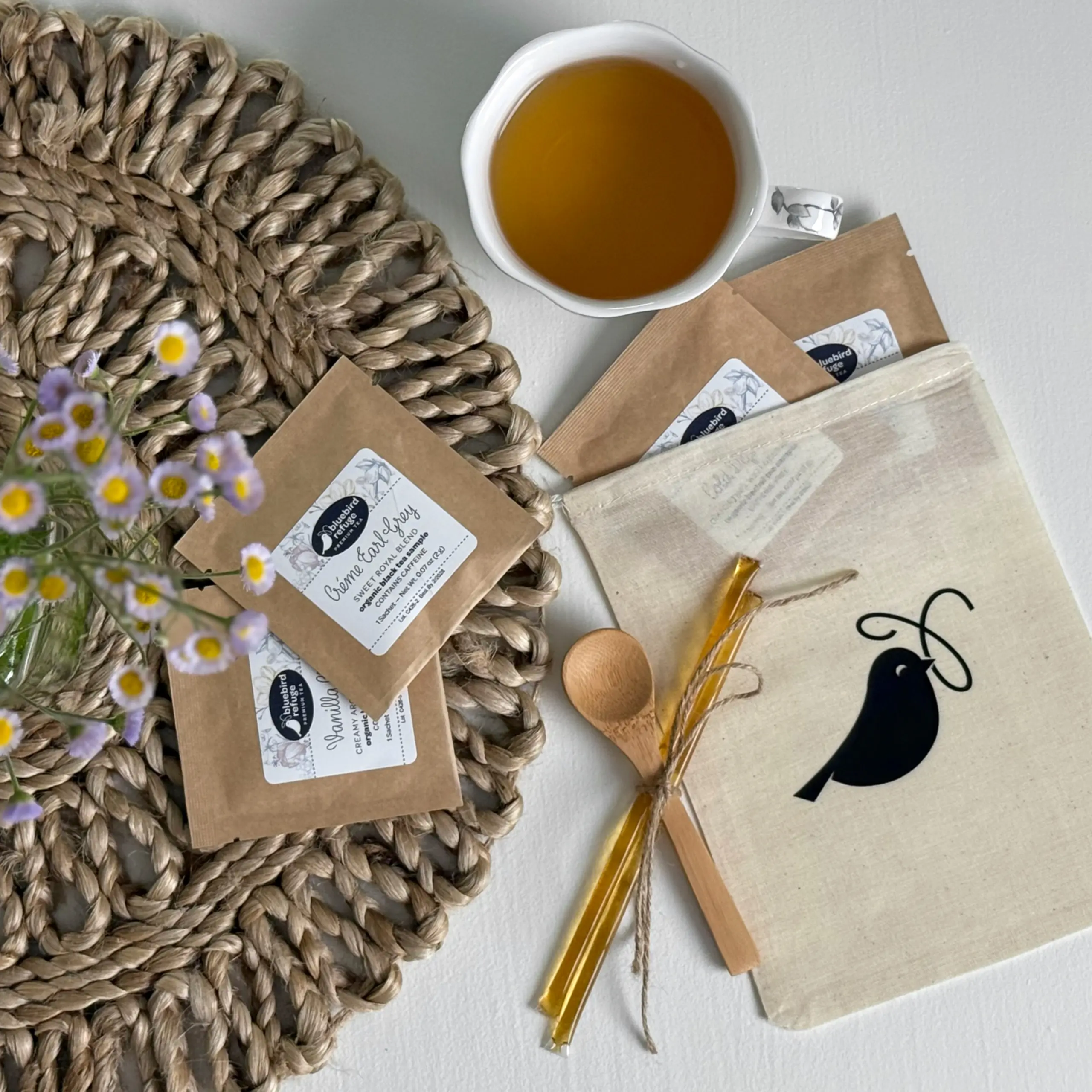 4 Tea Sampler Set on Table with Spoon and Honey Sticks